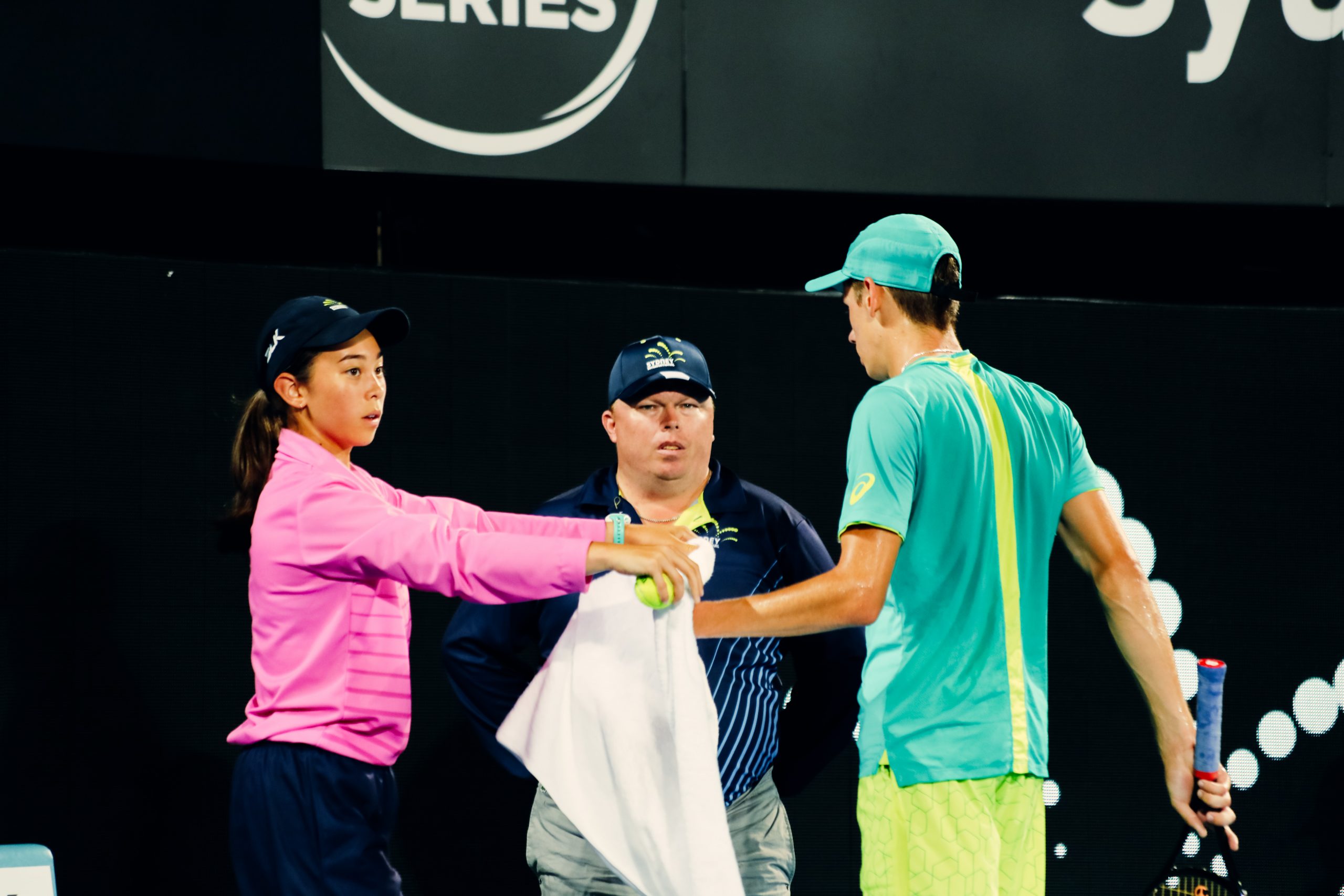 Ball girl with Alex de Minaur on Ken Rosewell Arena at Sydney International Tennis 2018