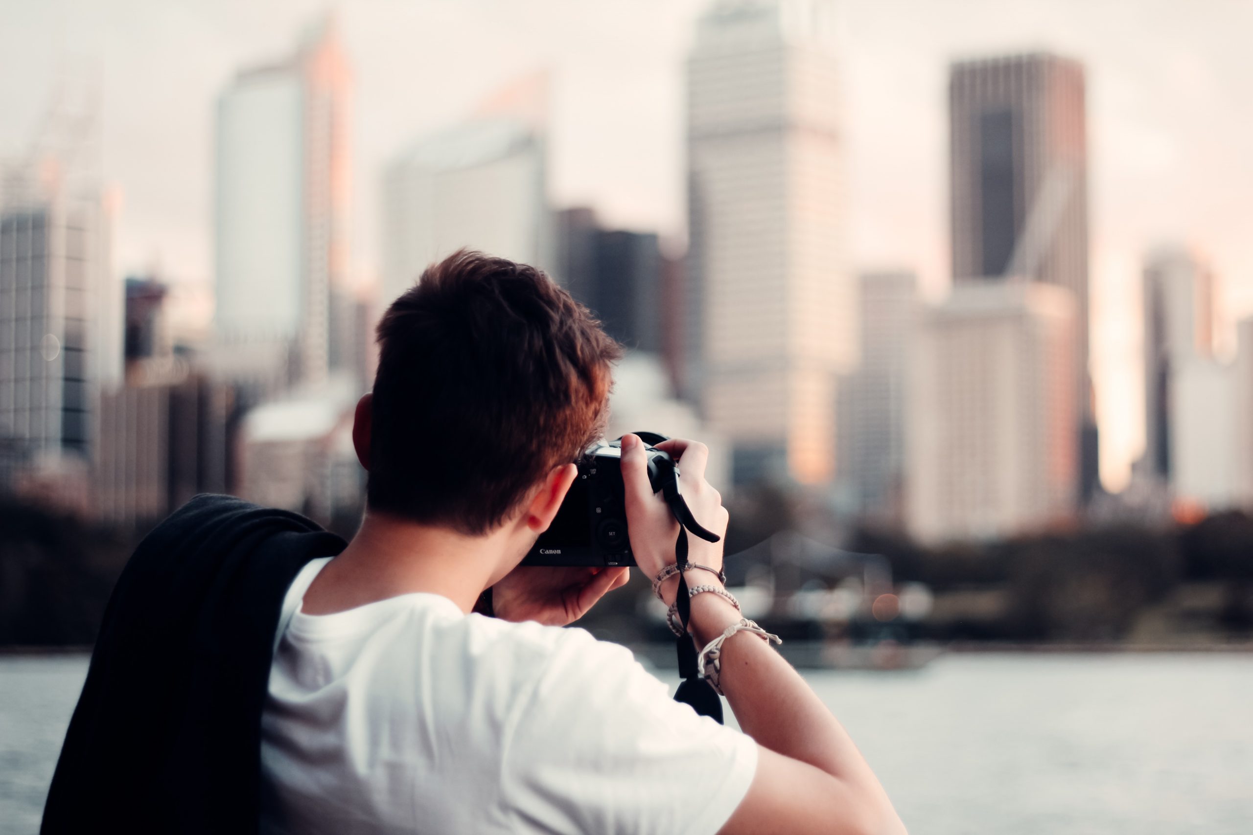 taking a photograph of Sydney building skyline at sunset at Mrs Macquarie's Chair (The Domain)