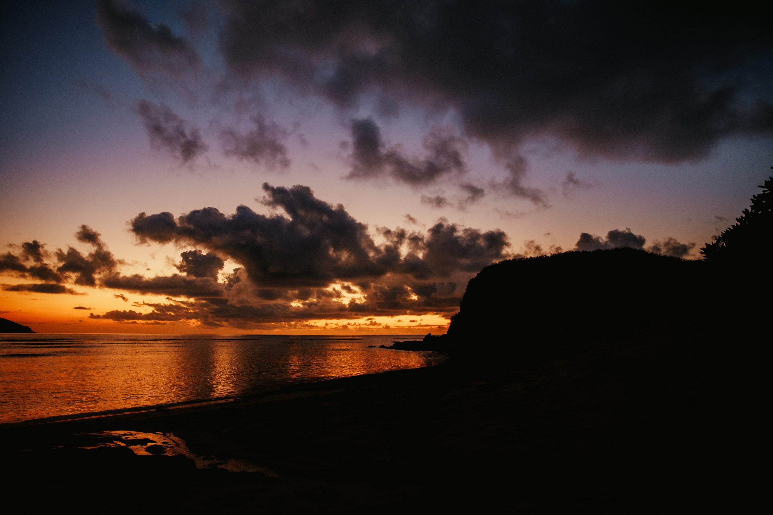 sunset over reef while on an island getaway in fiji