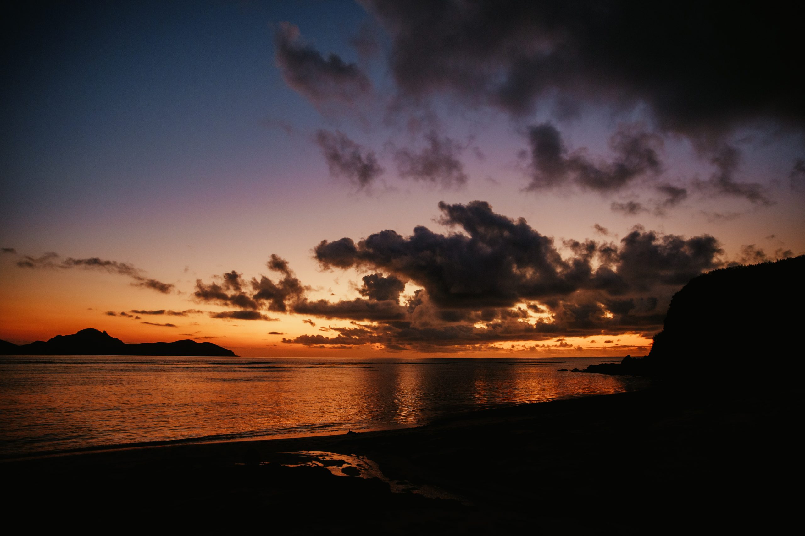 sunset over reef while on an island getaway in fiji
