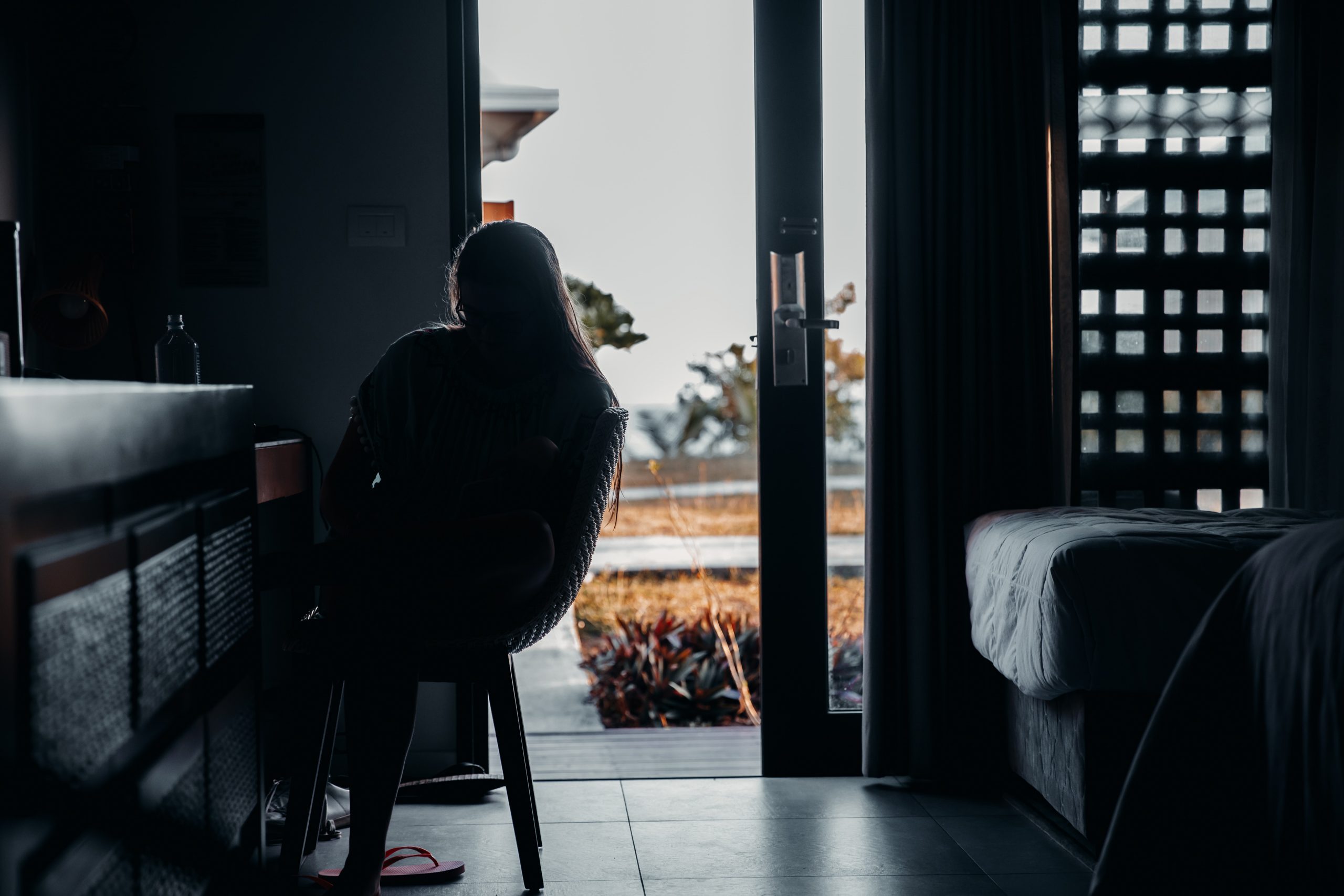 silhouette of girl sitting in beach hut on fiji island getaway