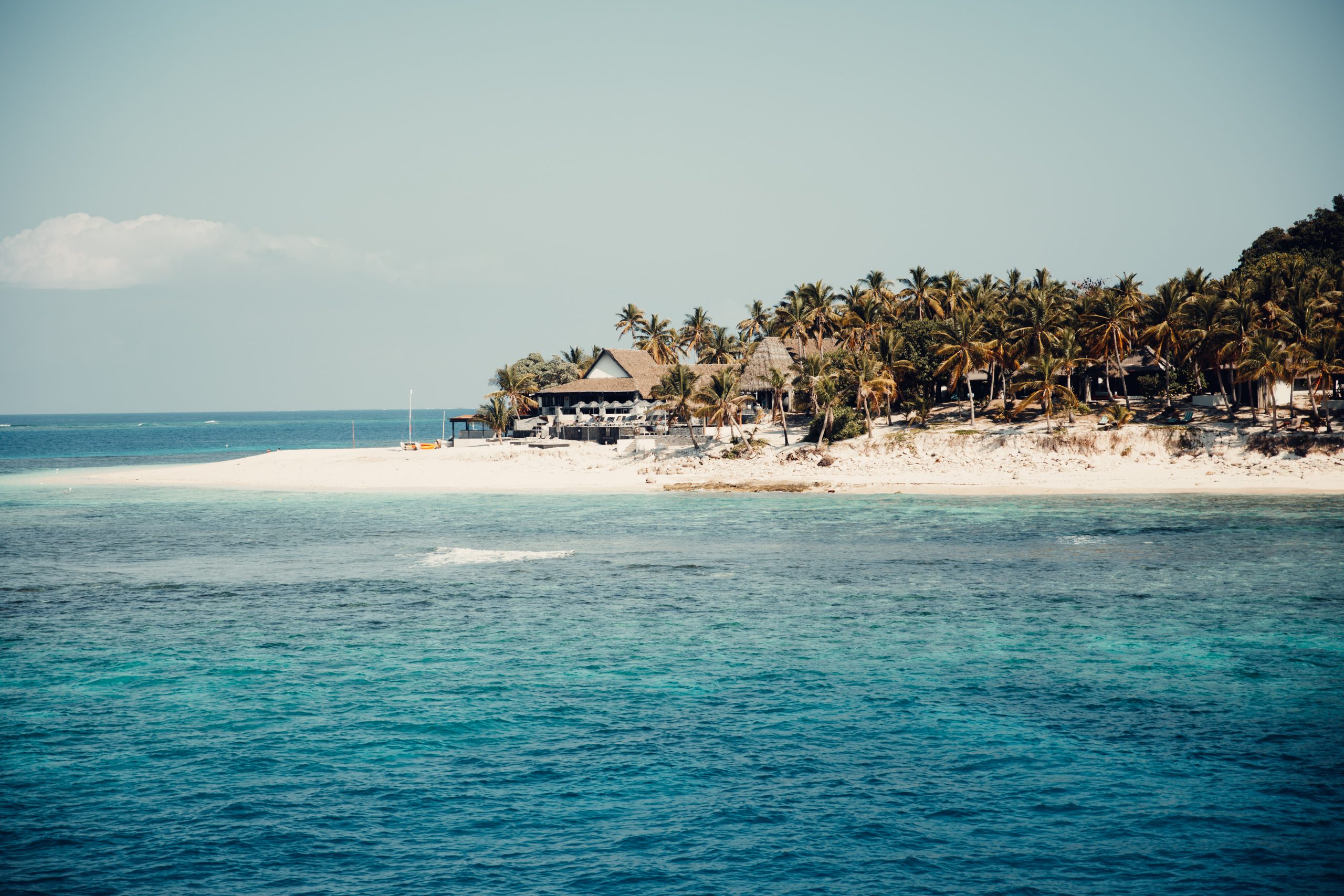 beach hut on an island in fiji overlooking blue ocean water and reef - travel and adventure photography