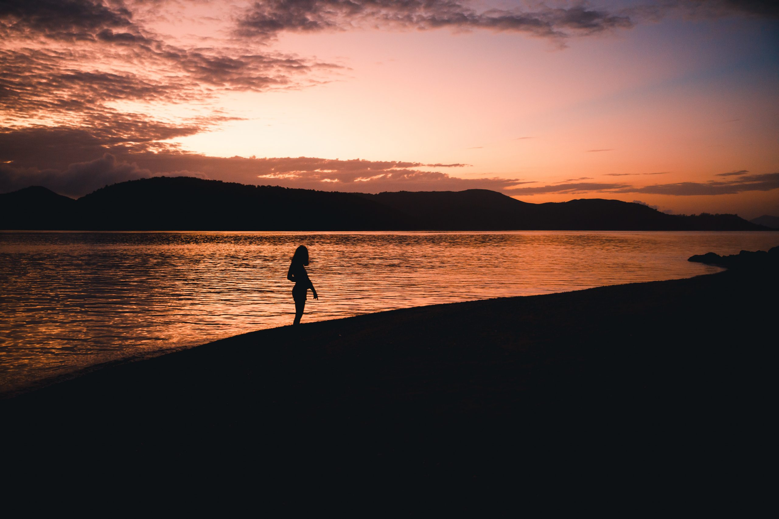 girl in front of sunrise on daydream island in the whitsunday islands (Hamilton island) Queensland Australia